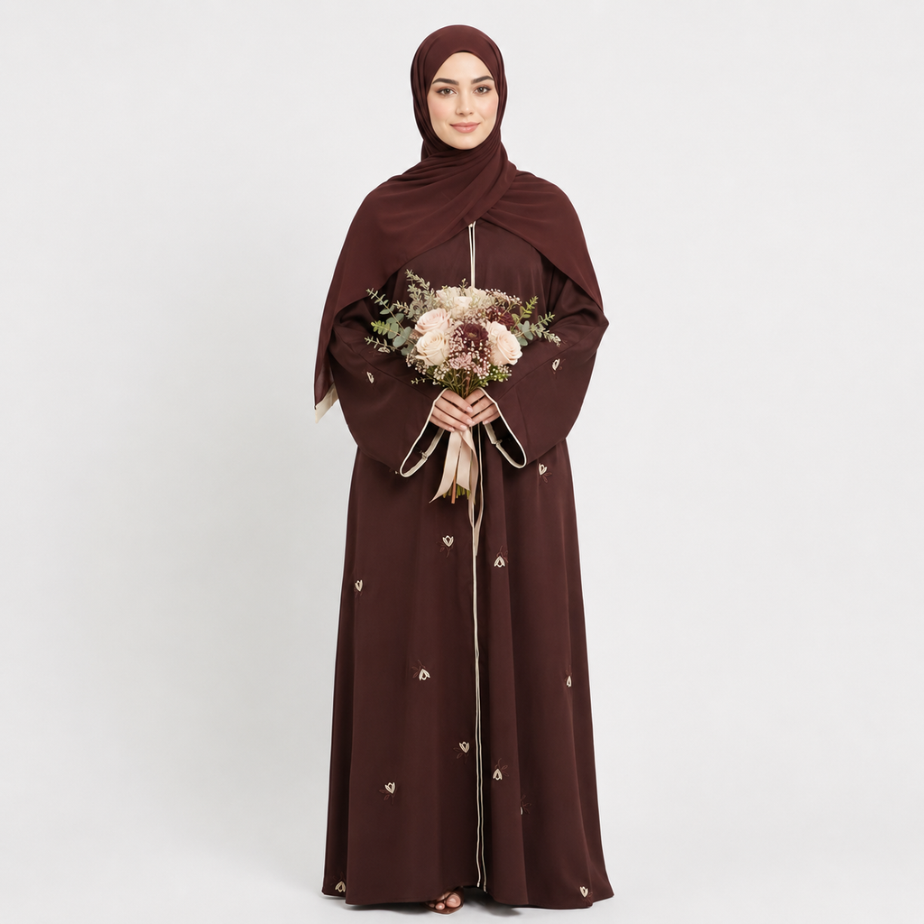 Woman wearing a brown abaya holding a bouquet of flowers on a white background