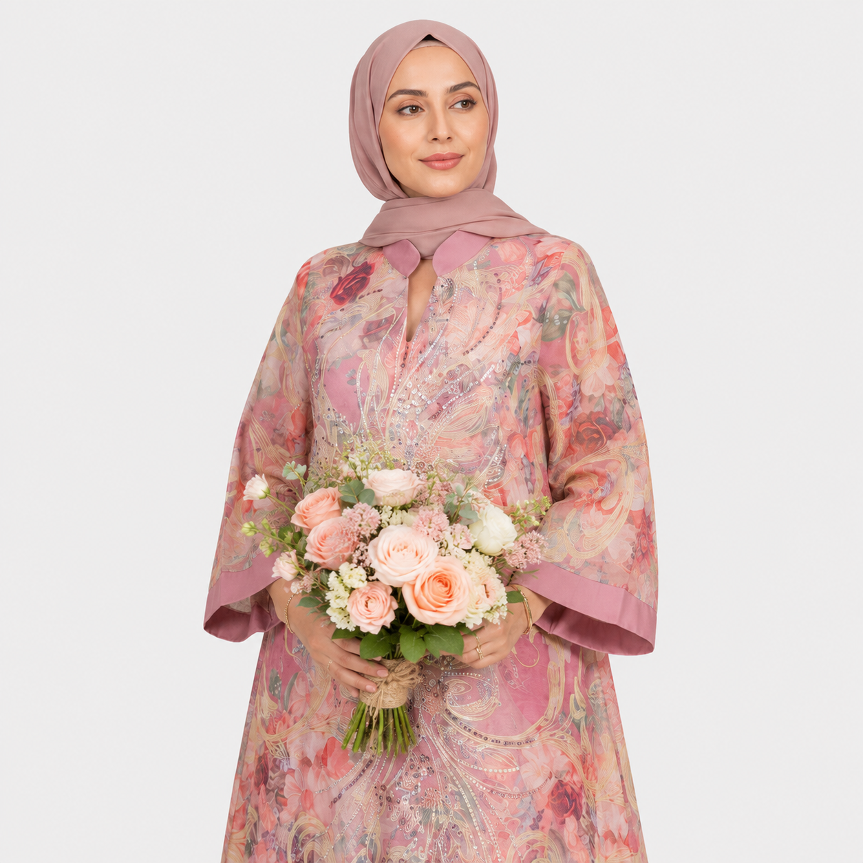 Woman wearing a floral dress and hijab holding a bouquet of flowers on a white background