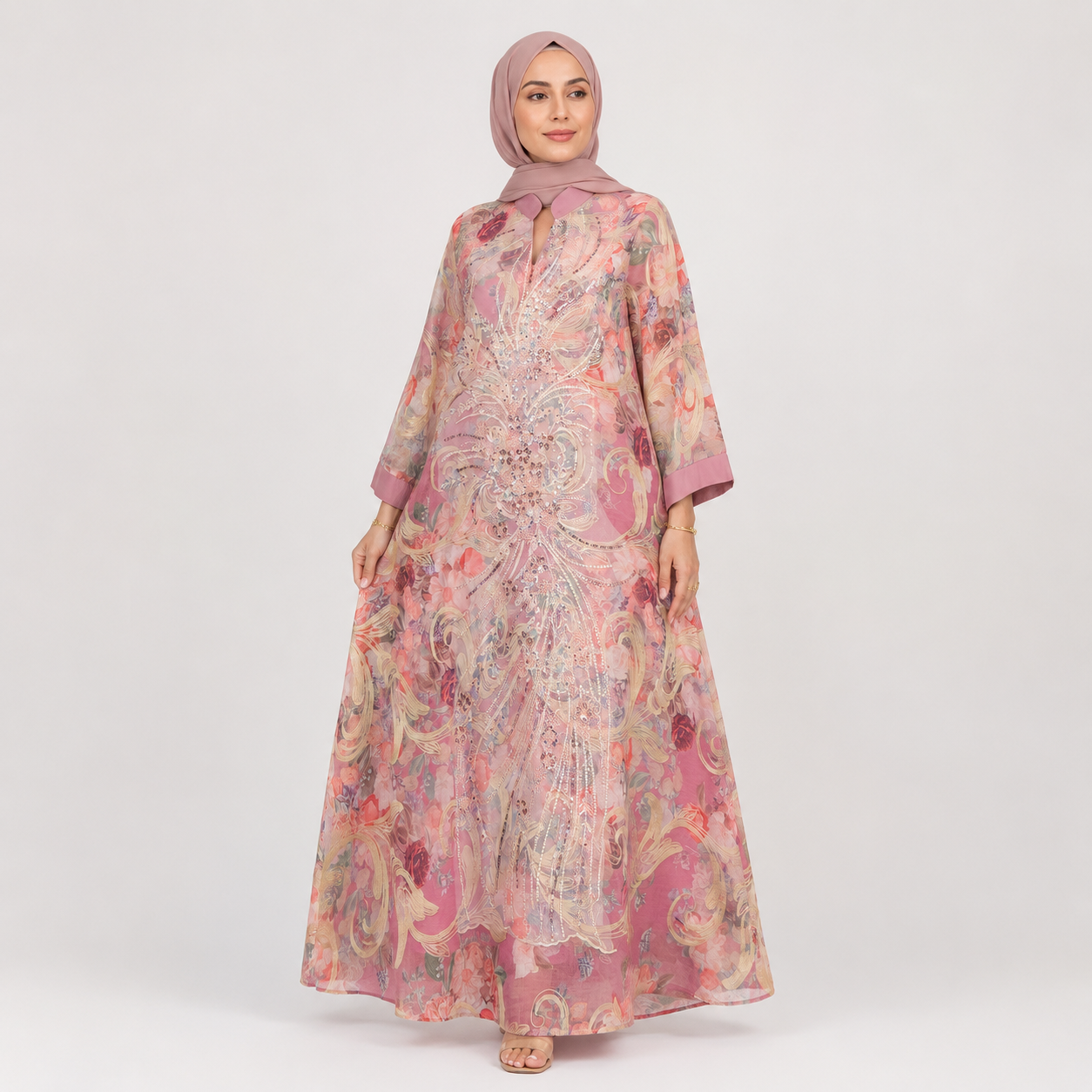 Woman wearing a floral dress and hijab on a white background
