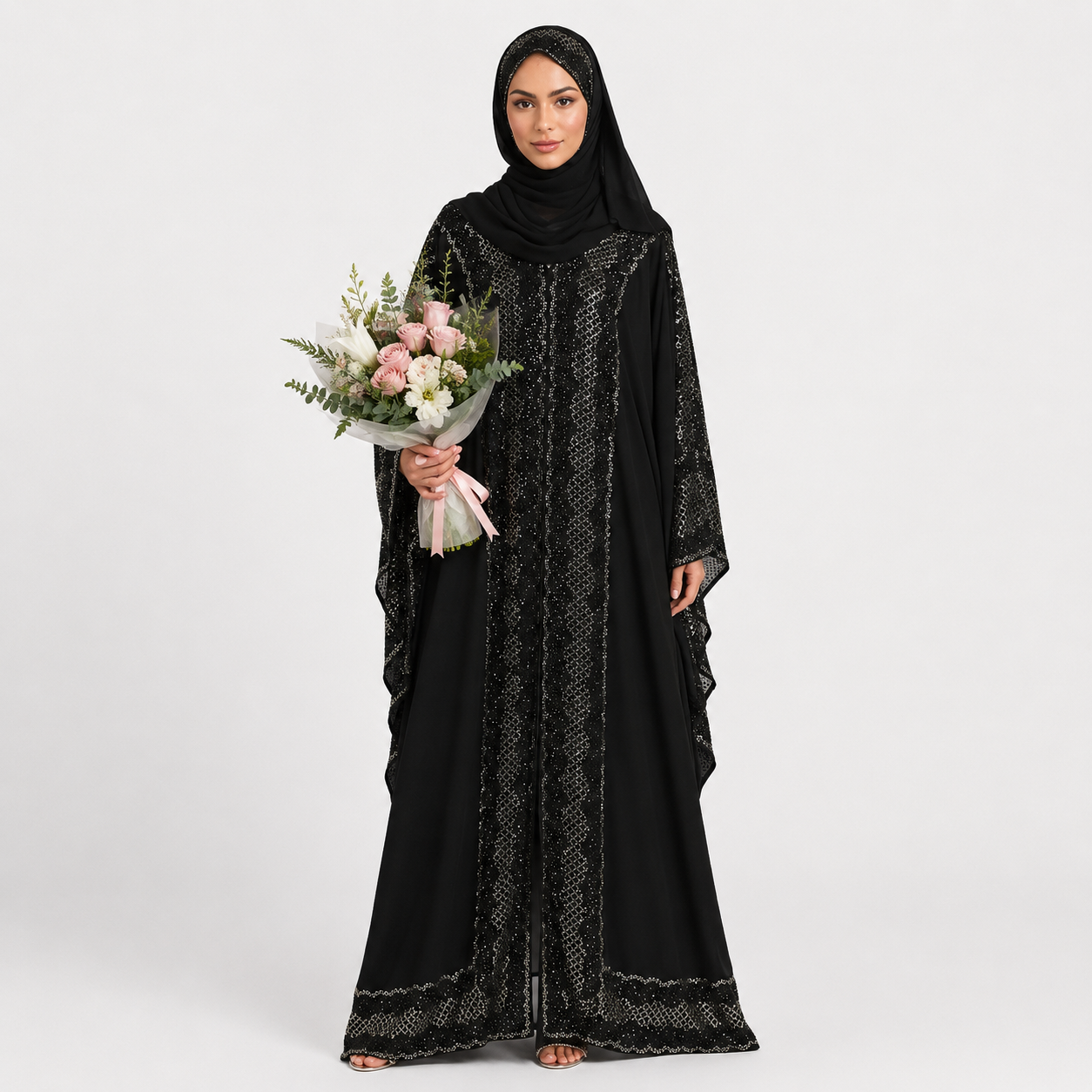 Woman wearing a black abaya holding a bouquet of flowers on a white background