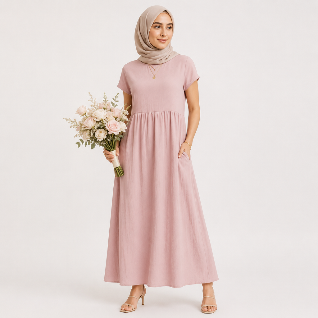 Woman in a pink dress holding flowers against a white background