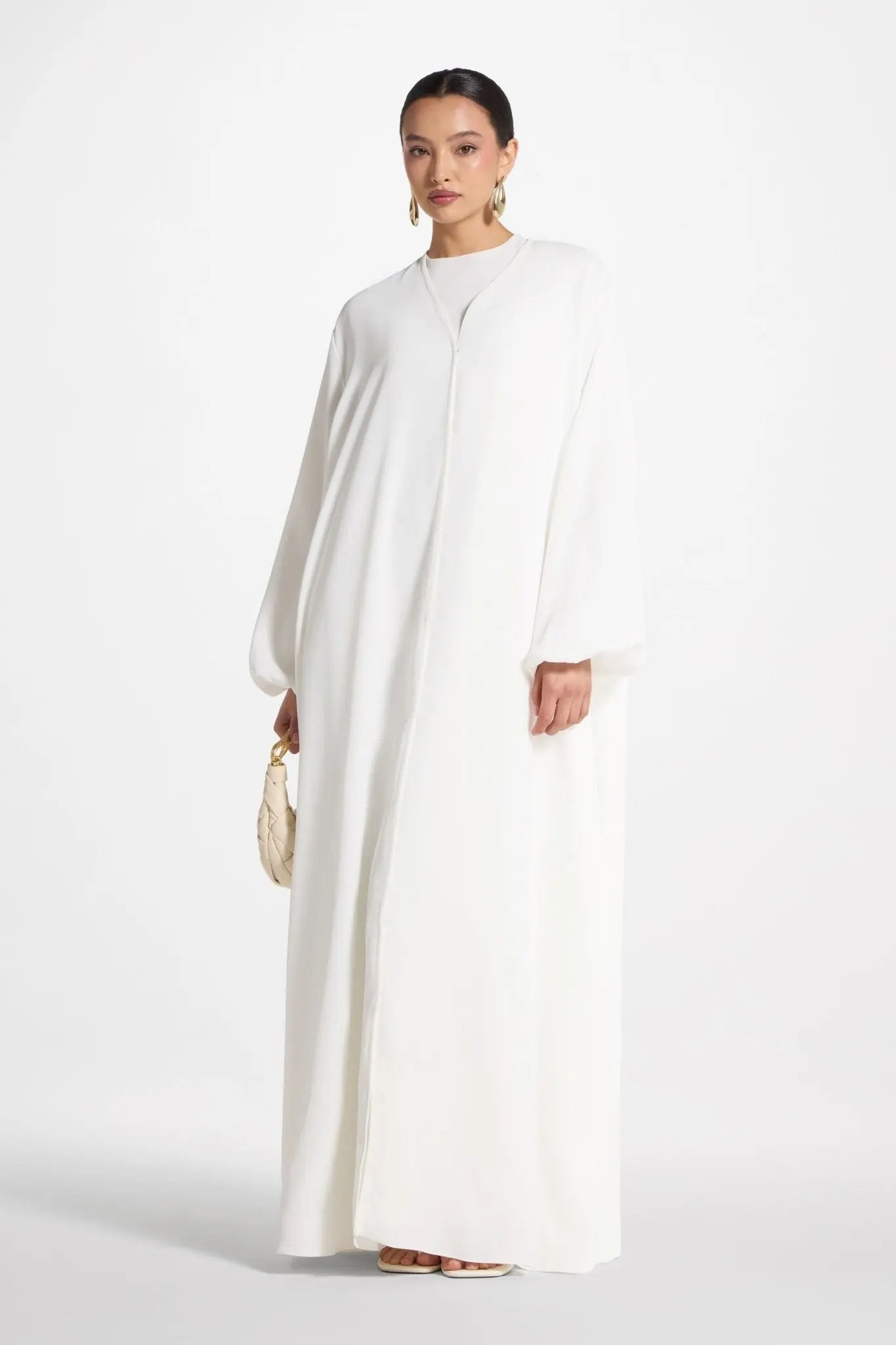 Woman wearing a white dress on a white background