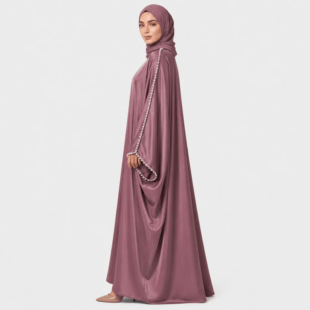 Mauve abaya with pearl details on a white background