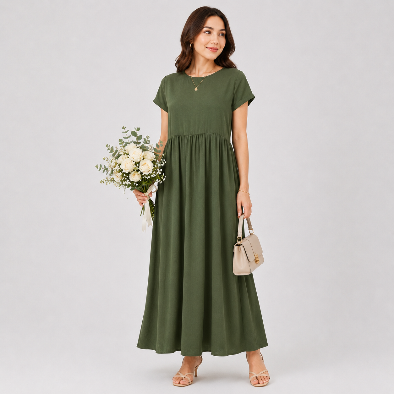 Woman wearing a green dress holding flowers and a handbag on a white background