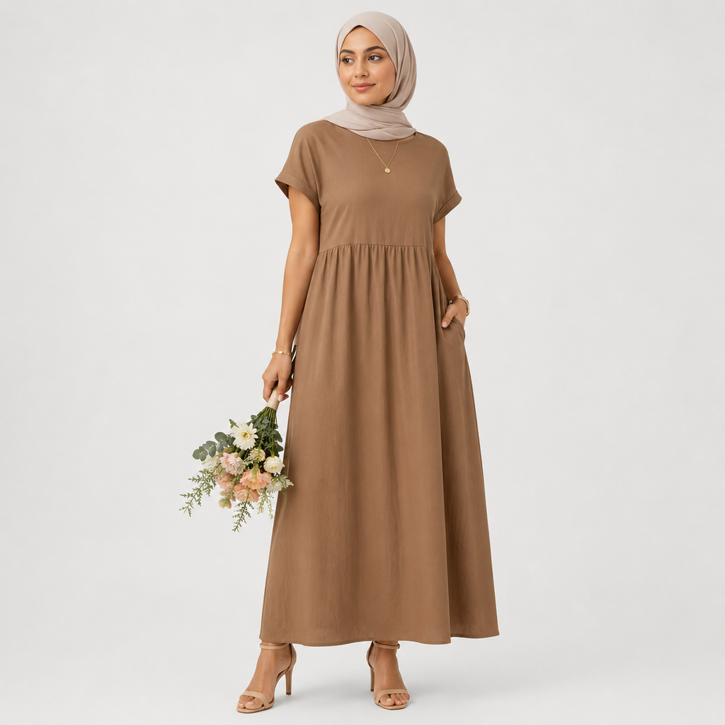 Woman wearing a brown dress holding flowers against a white background