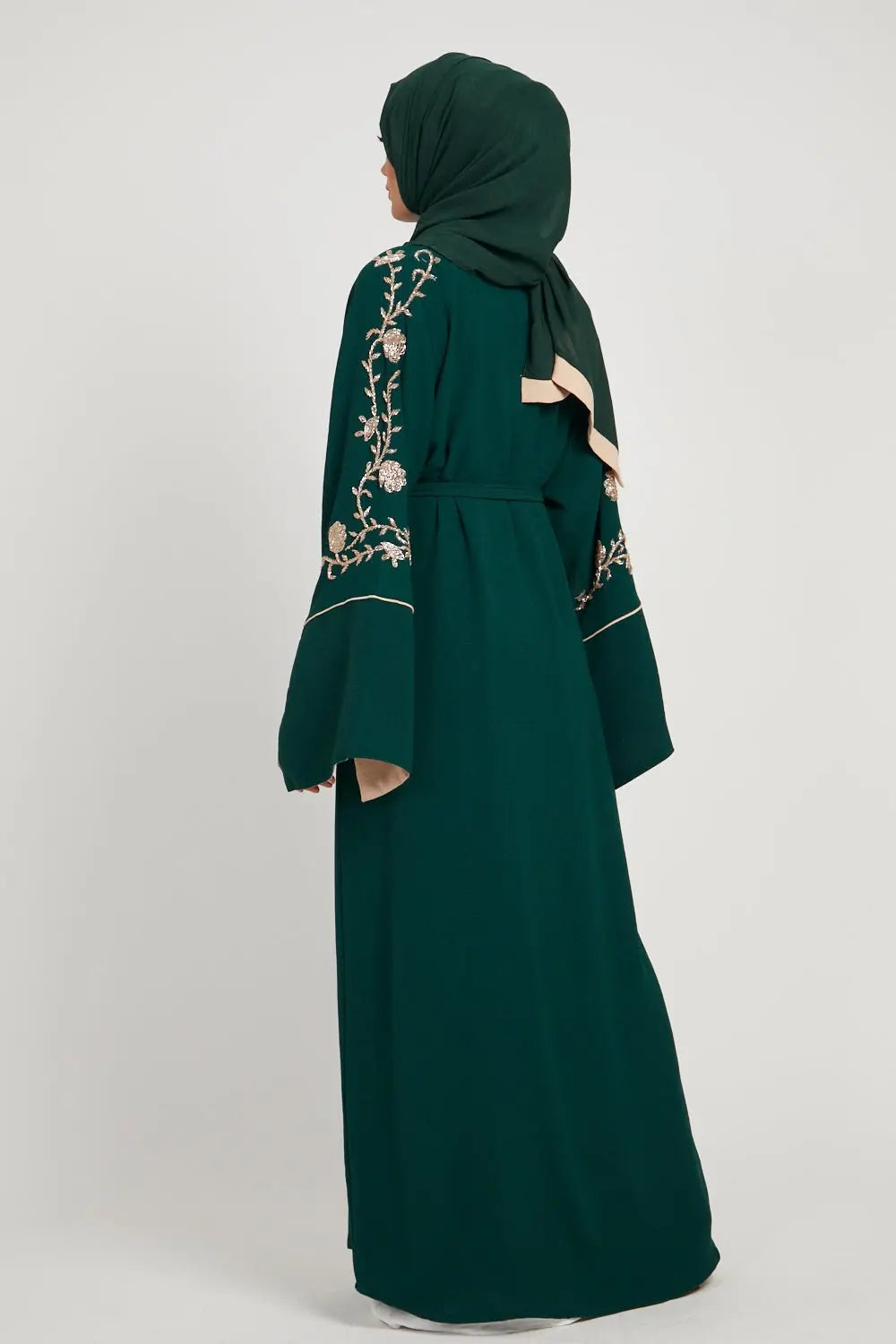 Green abaya with floral embroidery on a white background