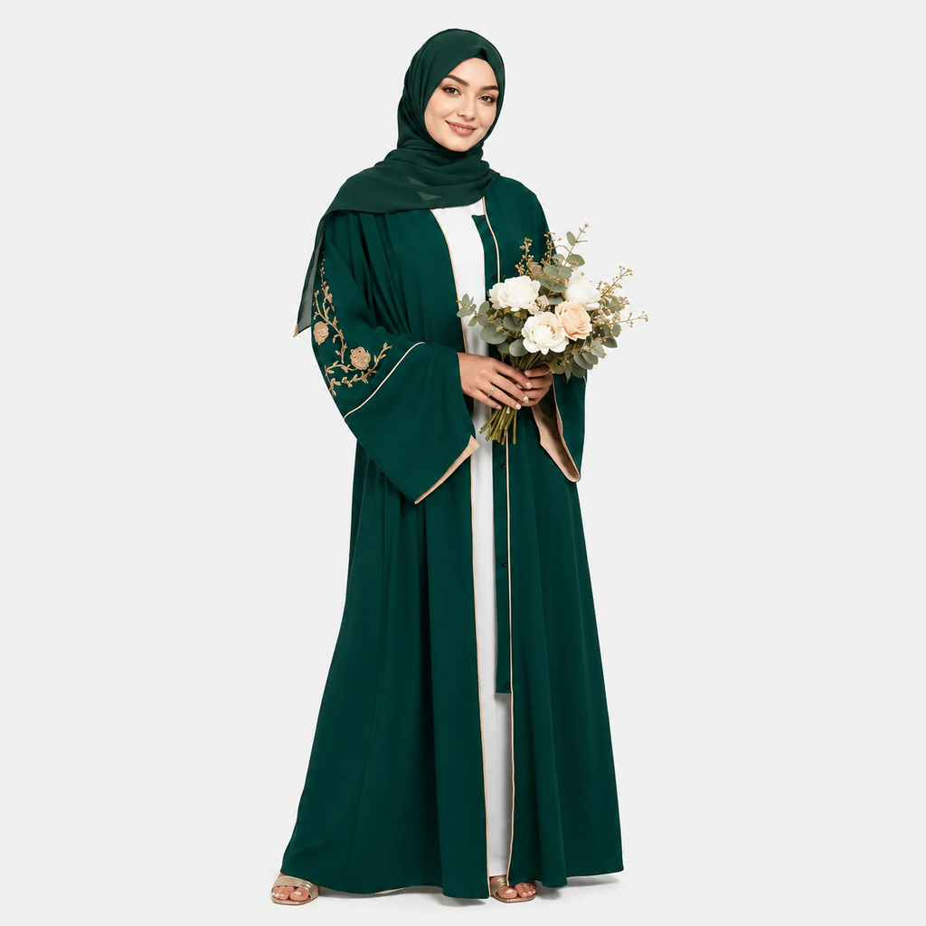 Woman wearing a green abaya with floral embroidery, holding flowers on a white background
