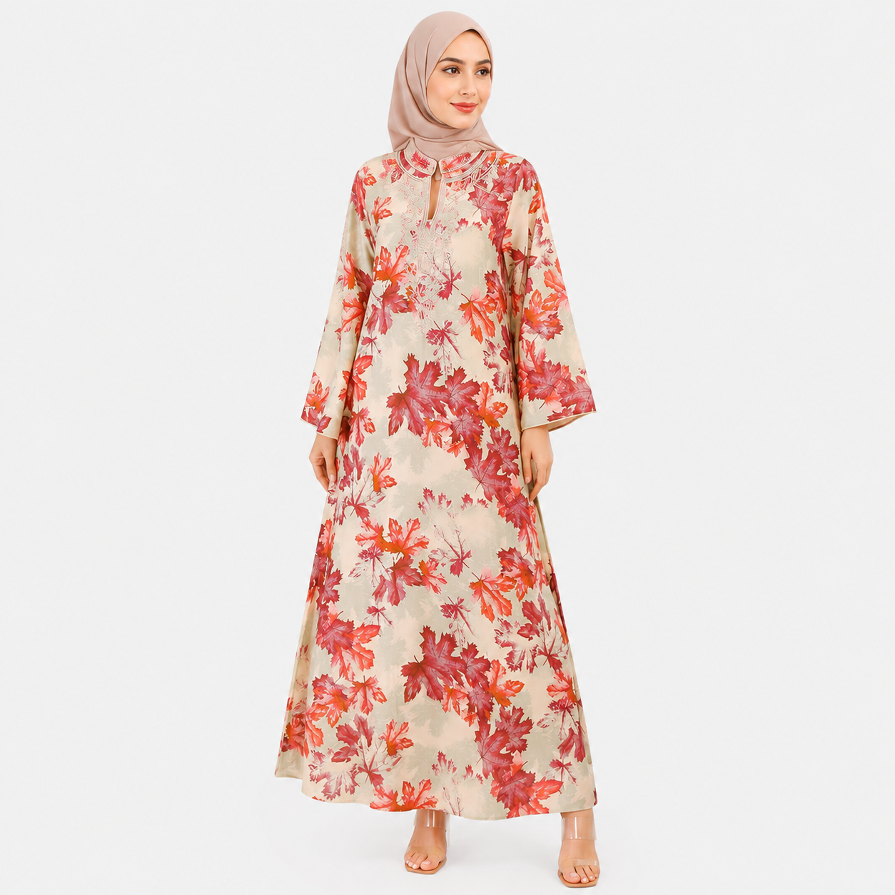 Woman wearing a floral dress with a hijab on a white background