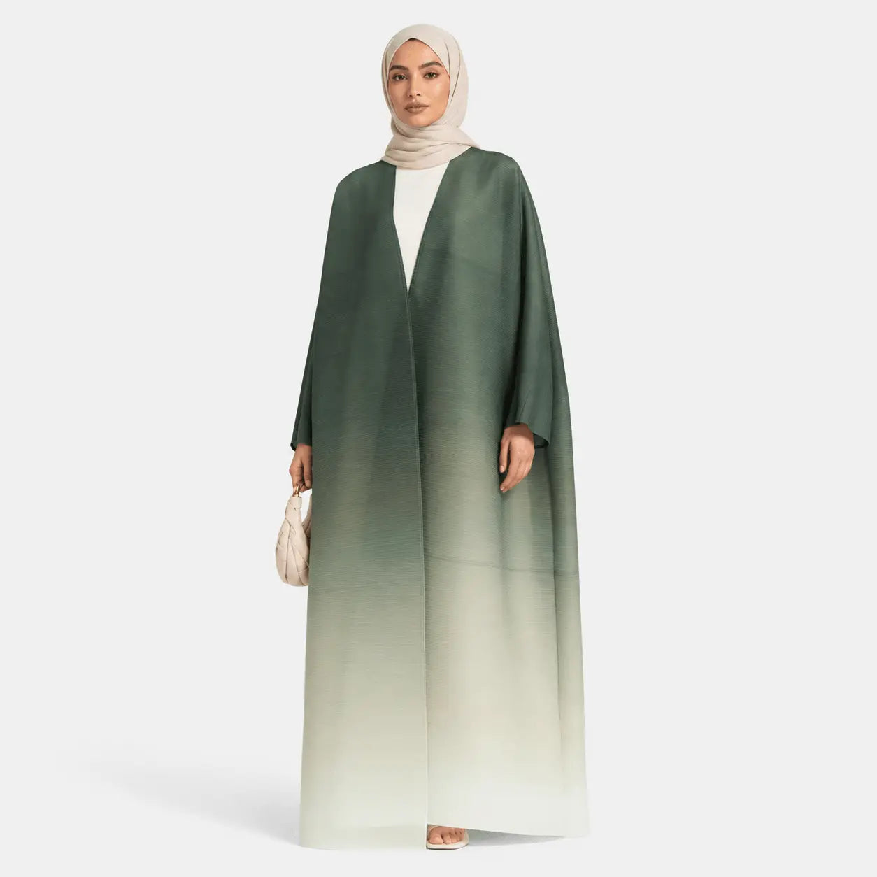 Woman wearing a green to white gradient abaya on a white background