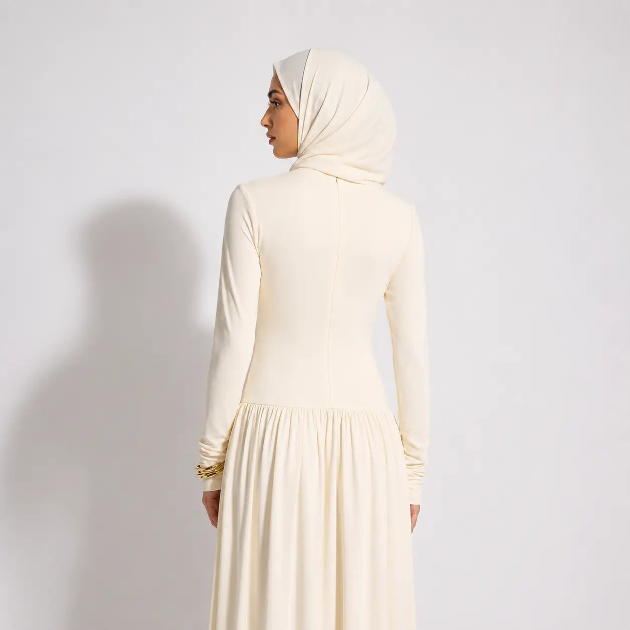 Cream hijab dress with long sleeves and pleated skirt, modest fashion for women