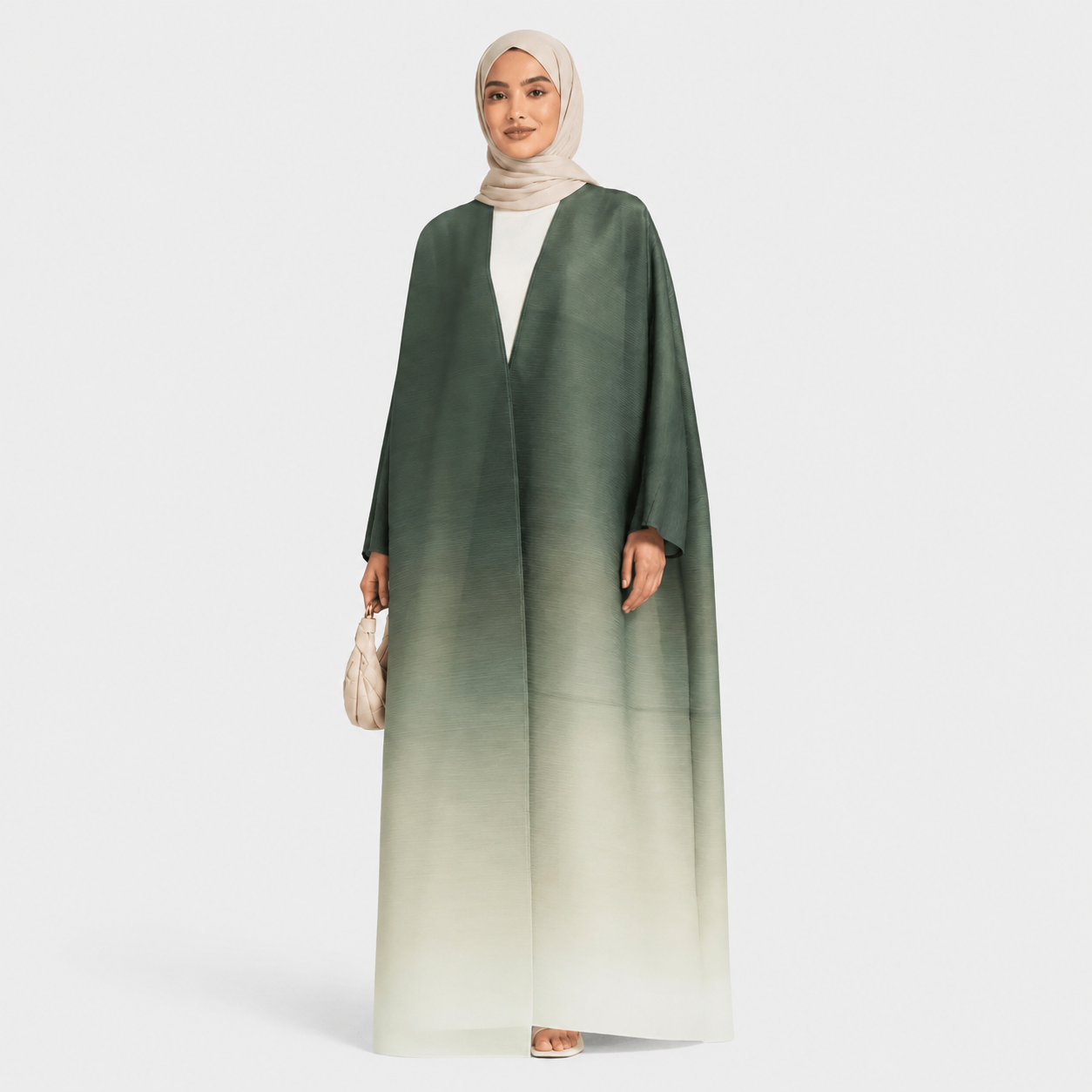 Woman wearing a green to white gradient abaya on a light gray background