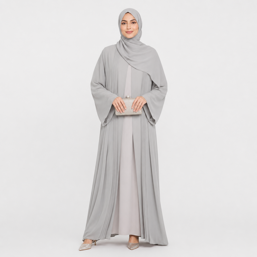 Woman wearing a gray abaya and hijab on a white background