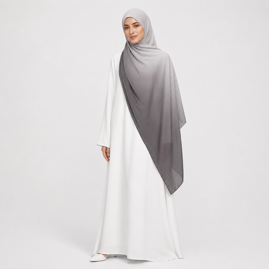 Woman wearing a white dress with a gray hijab on a light gray background