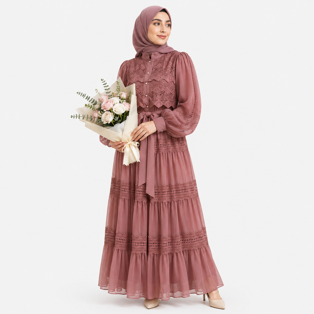 Woman wearing a pink hijab and dress holding flowers on a white background