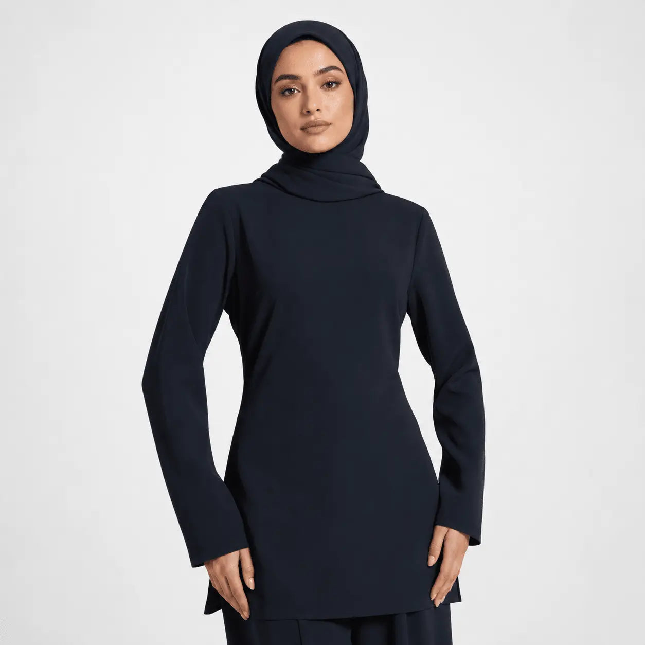 Person wearing a black outfit with a hood on a white background