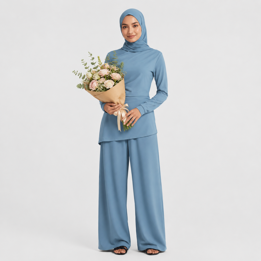 Woman in a blue outfit holding a bouquet of flowers on a light gray background