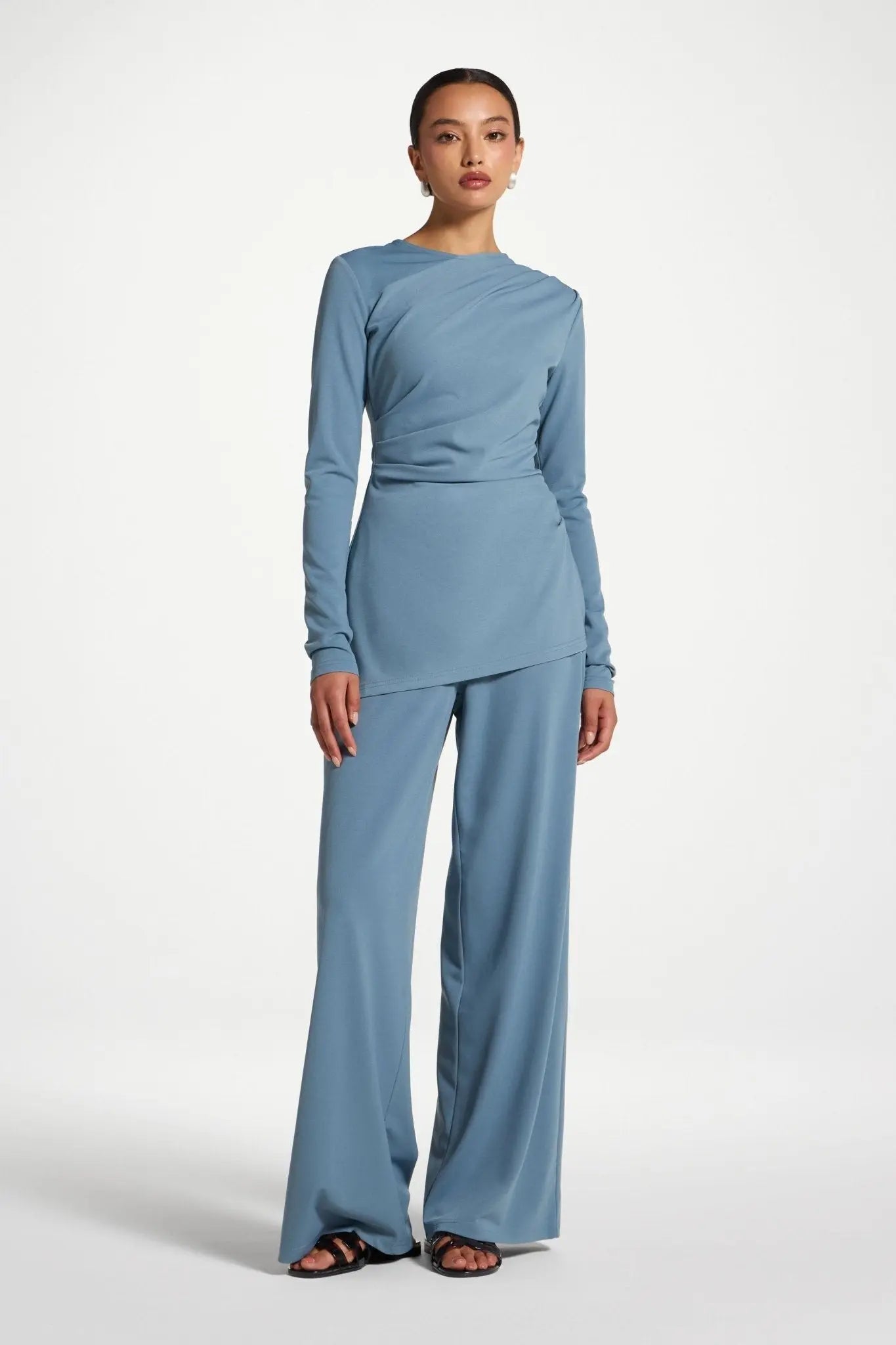Woman wearing a blue outfit on a white background