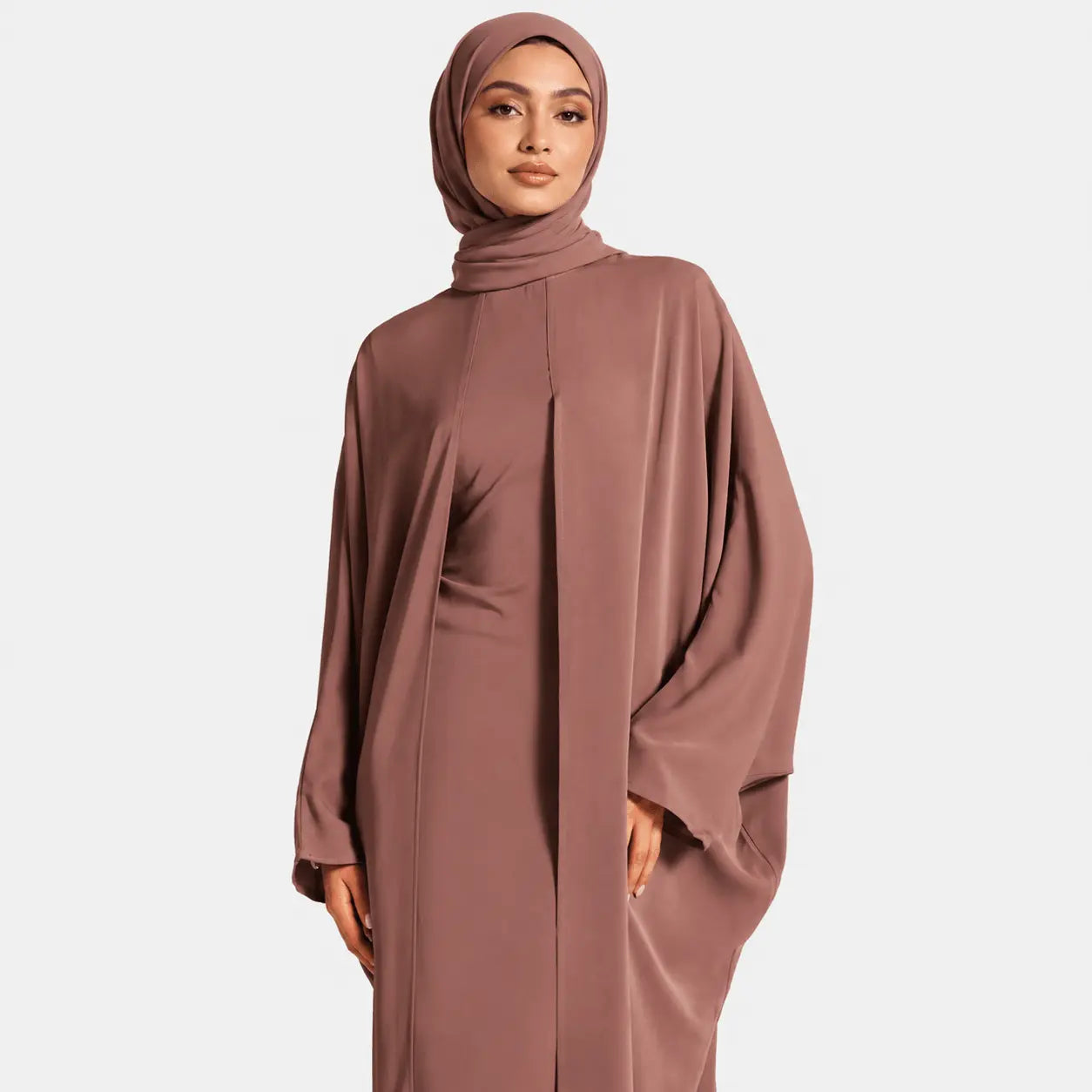Woman wearing a brown abaya on a white background
