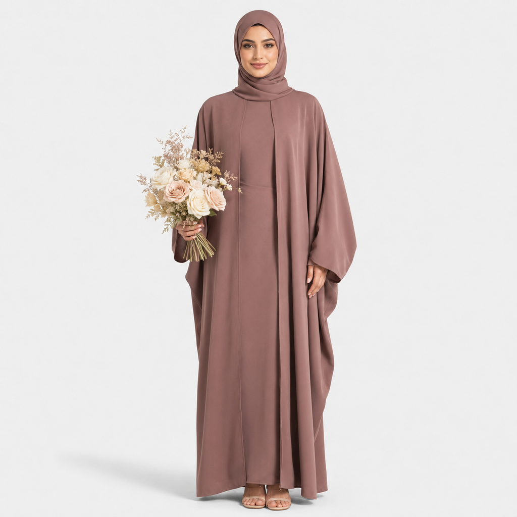 Woman wearing a long brown dress holding flowers on a white background