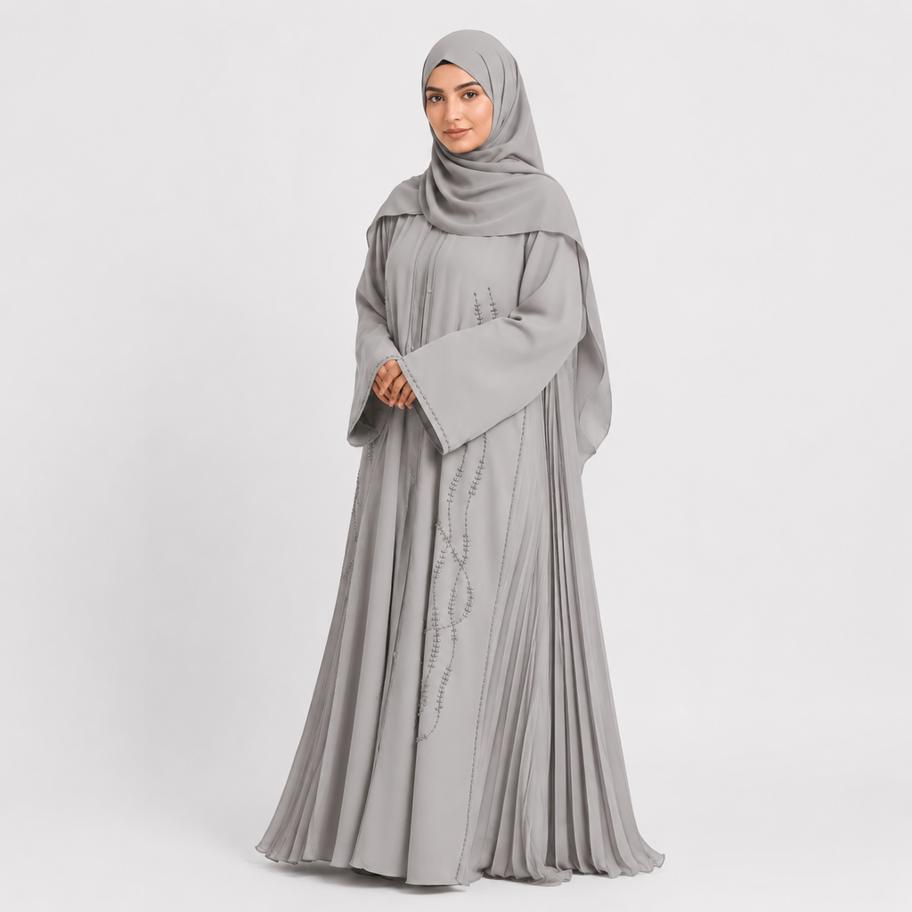 Woman wearing a gray abaya with a matching hijab on a white background