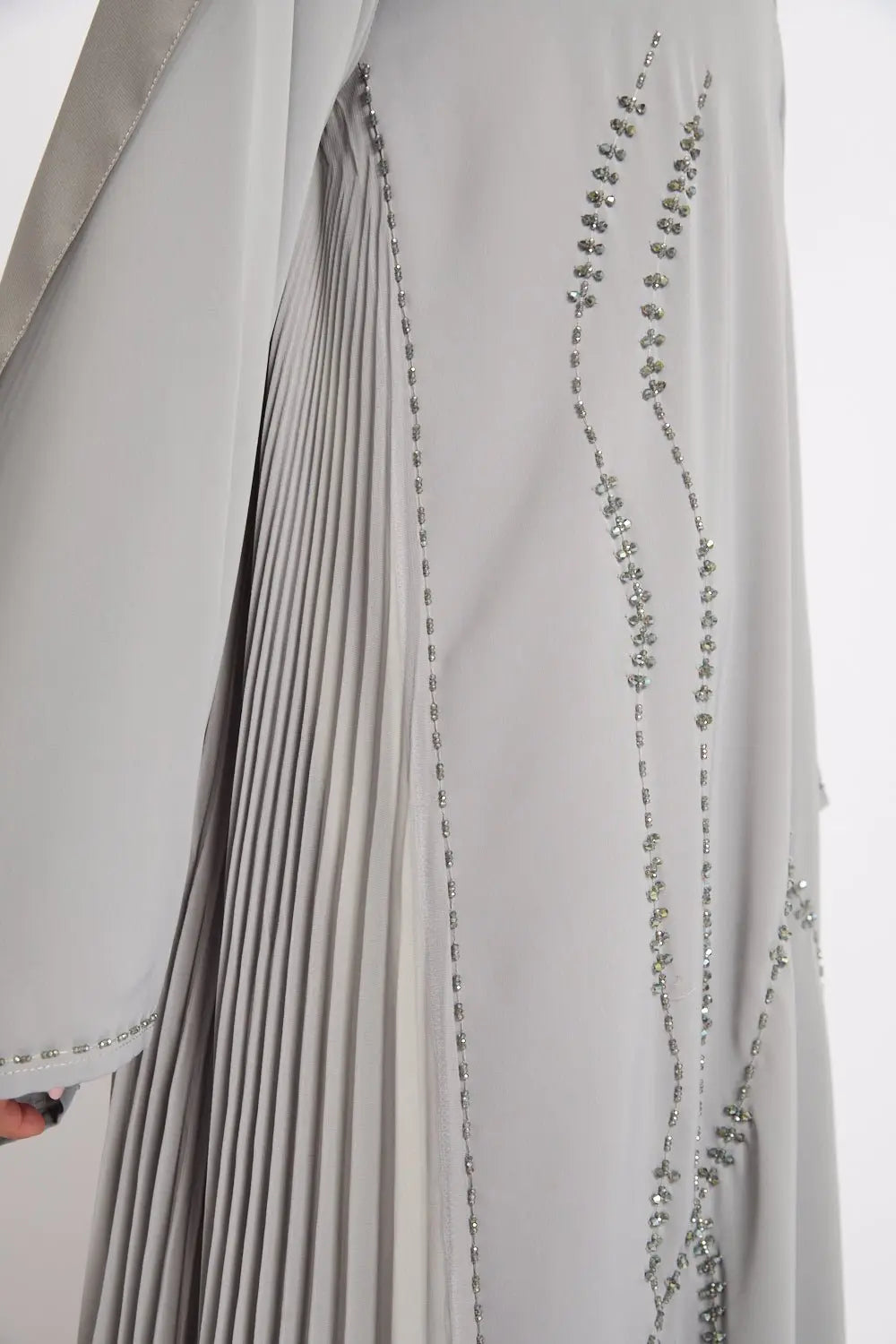 Close-up of a gray fabric with decorative stitching on a white background