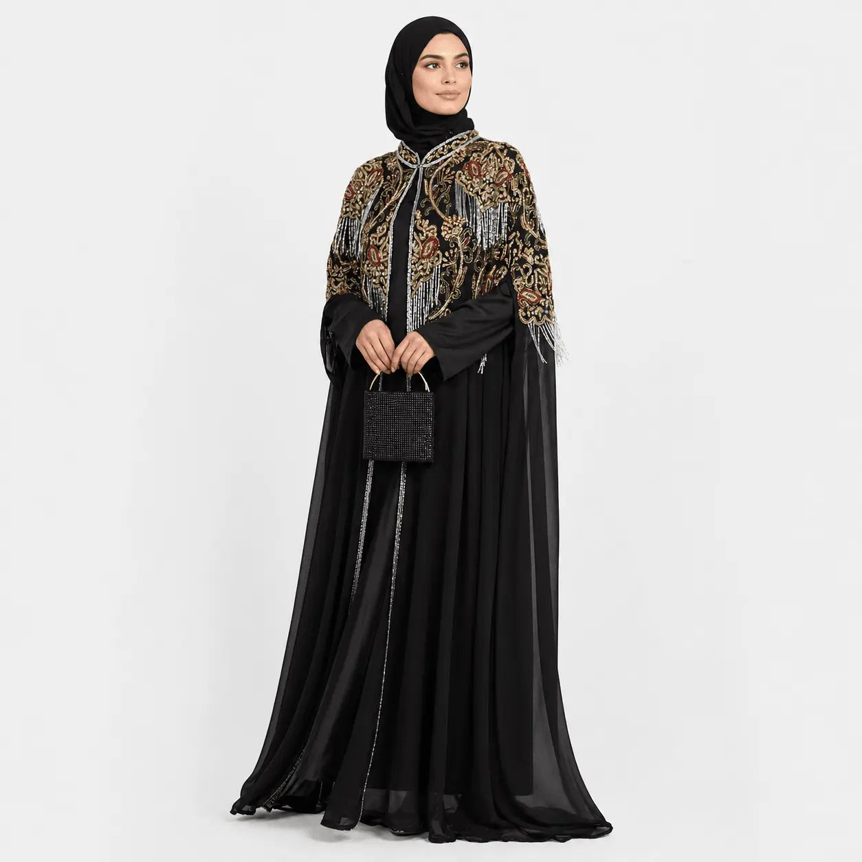 Woman wearing a black abaya with floral embroidery on a white background