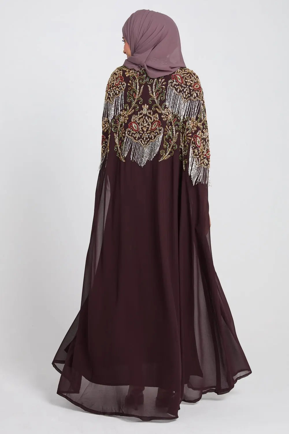 Long dark brown dress with intricate beaded top on a white background