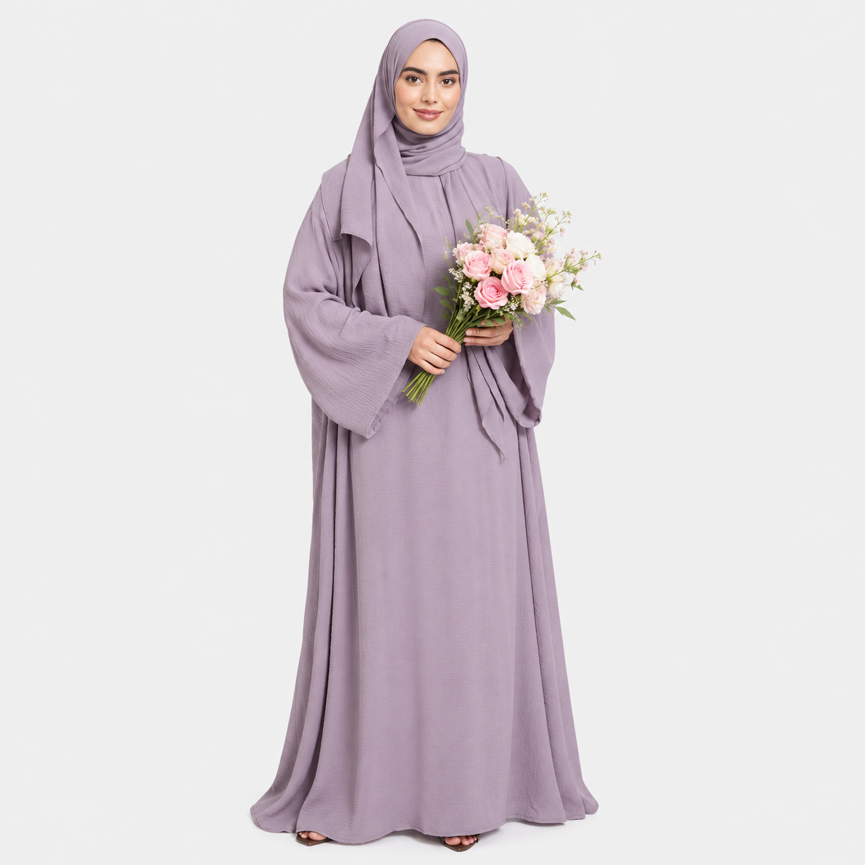 Woman in a long, light purple dress holding a bouquet of flowers on a white background