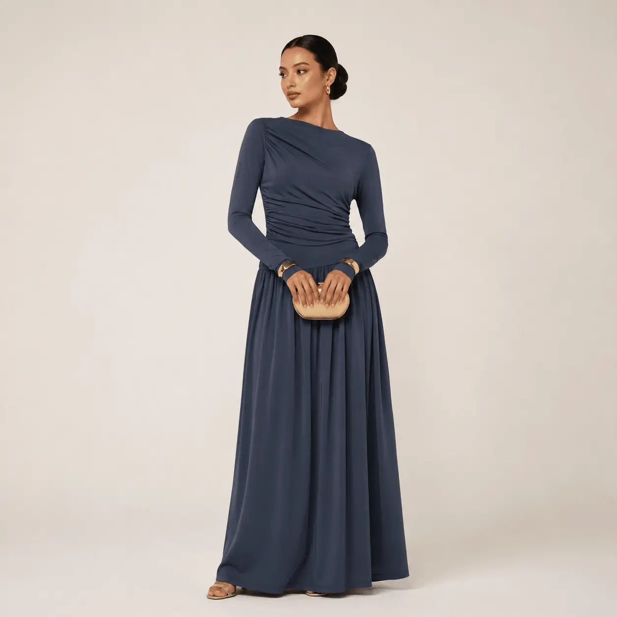 Elegant navy blue long-sleeve evening gown with ruched bodice and flowing skirt, perfect for formal events.