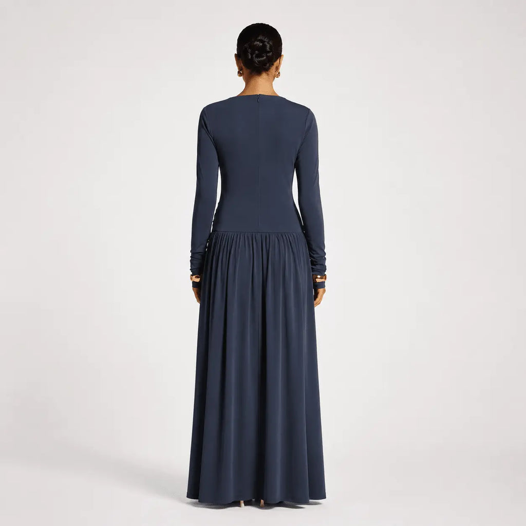 Navy blue long sleeve maxi dress with pleated skirt, elegant back view
