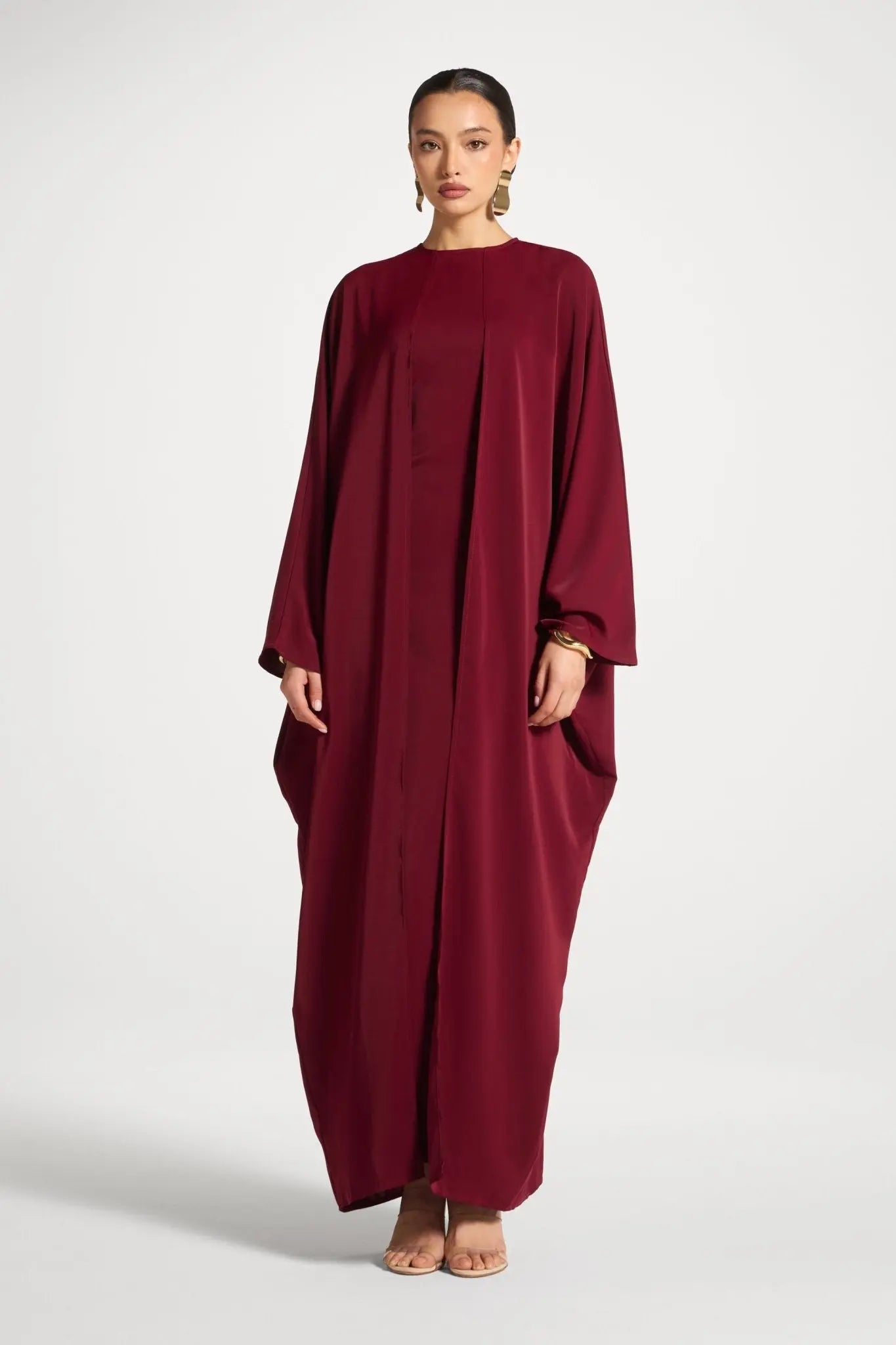 Woman wearing a burgundy dress on a white background