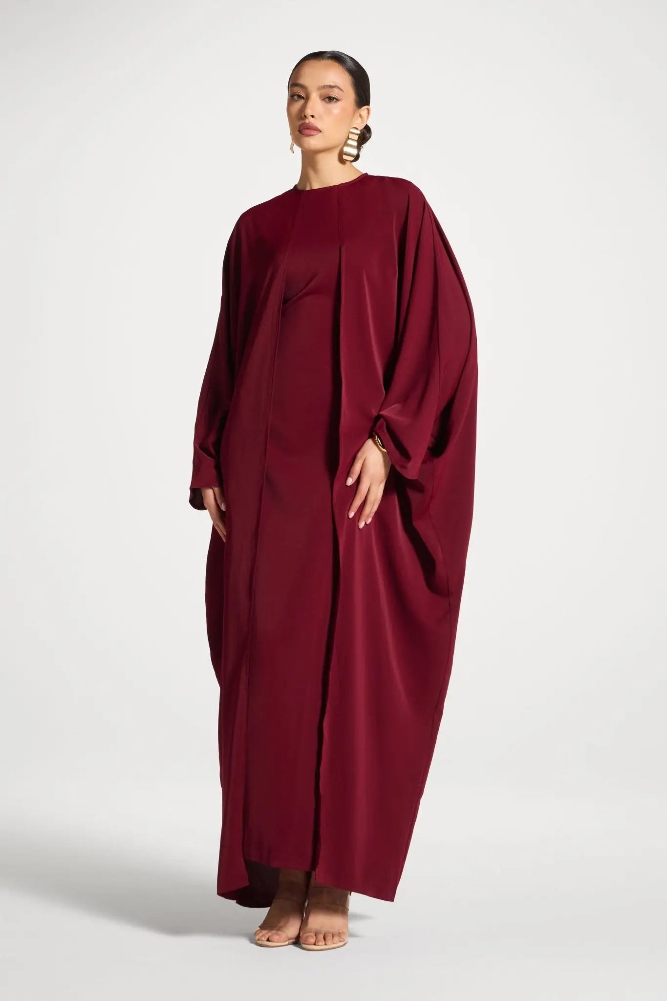 Woman wearing a burgundy dress on a white background