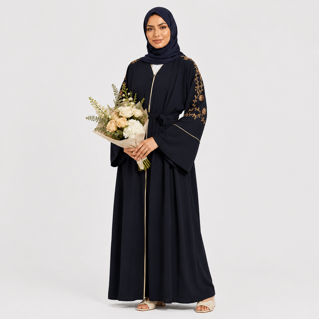 Woman in a black abaya with floral embroidery holding flowers on a light gray background