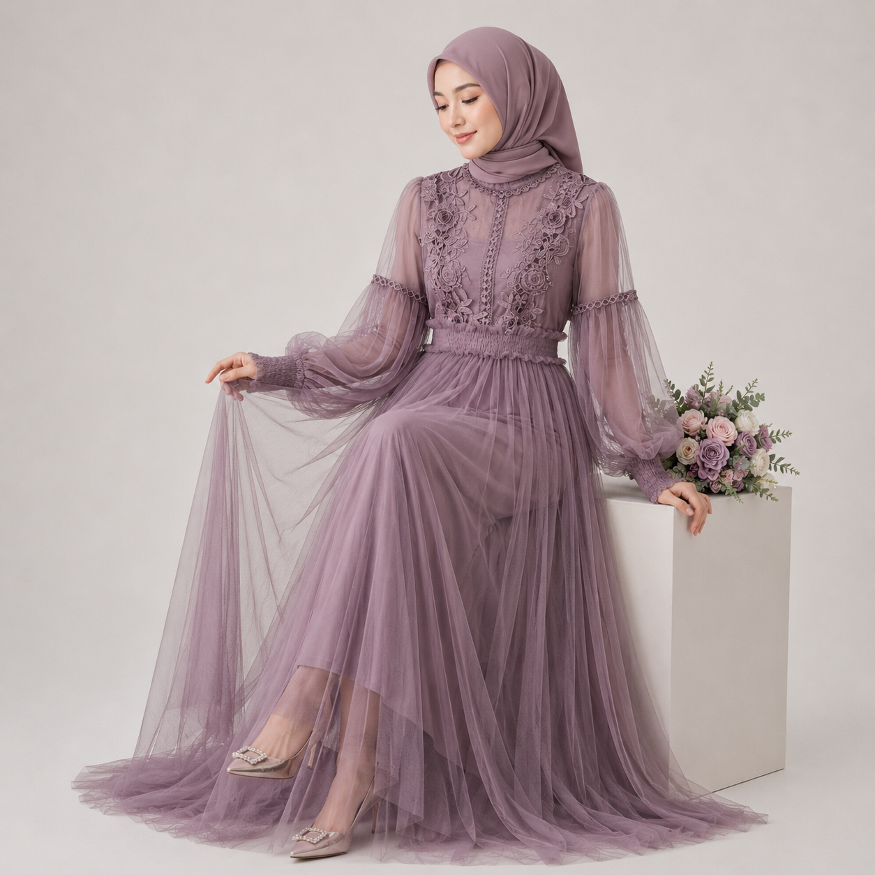 Woman in a long, sheer purple dress with lace details against a light gray background.