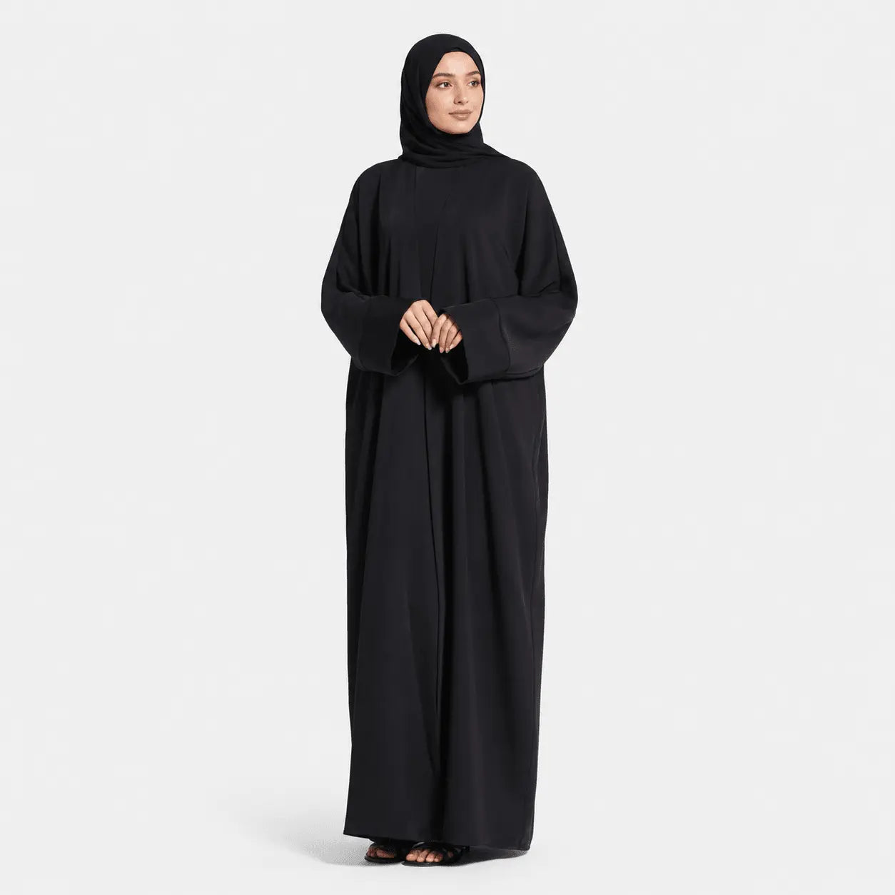 Person wearing a black abaya on a white background