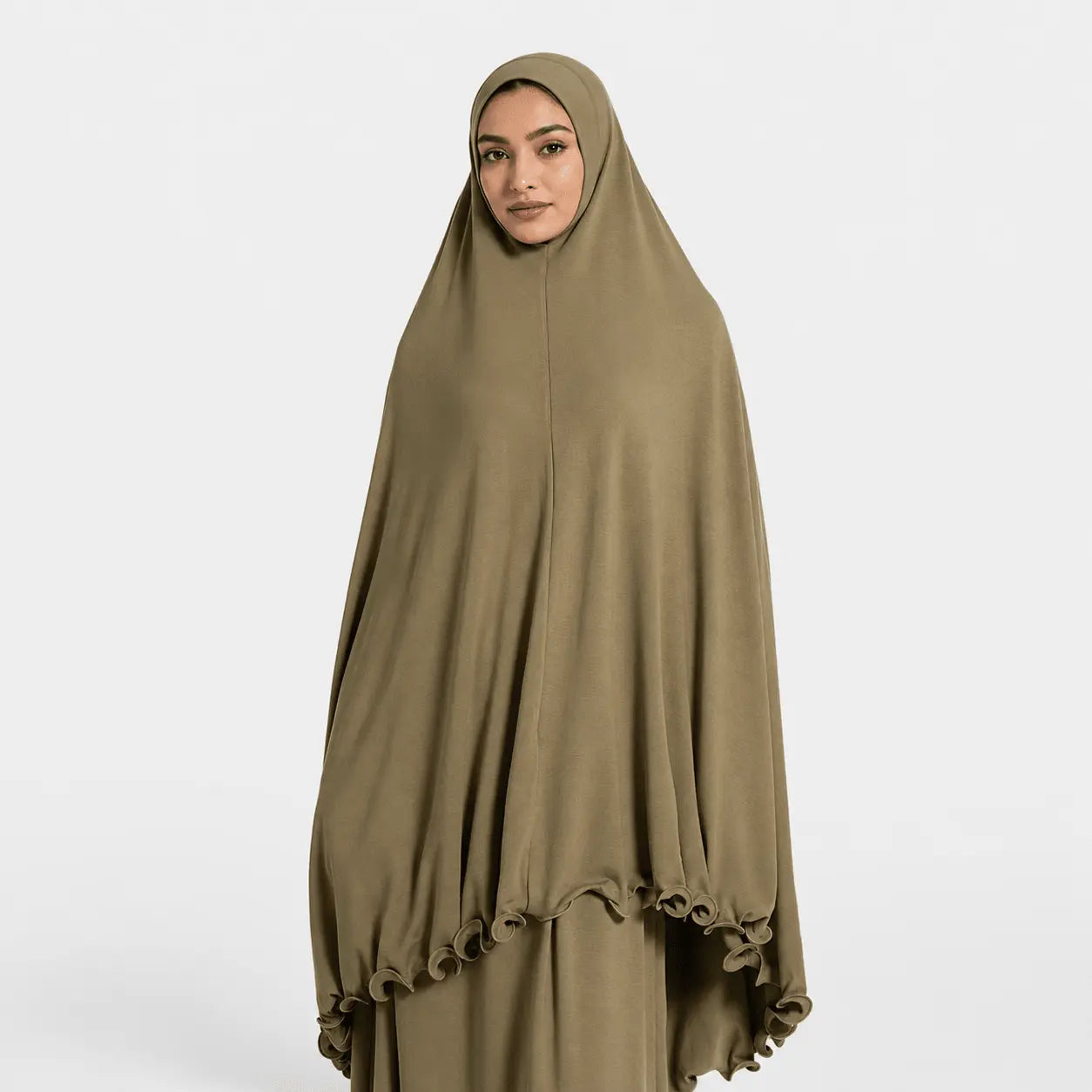 Woman wearing a brown hijab and dress on a white background