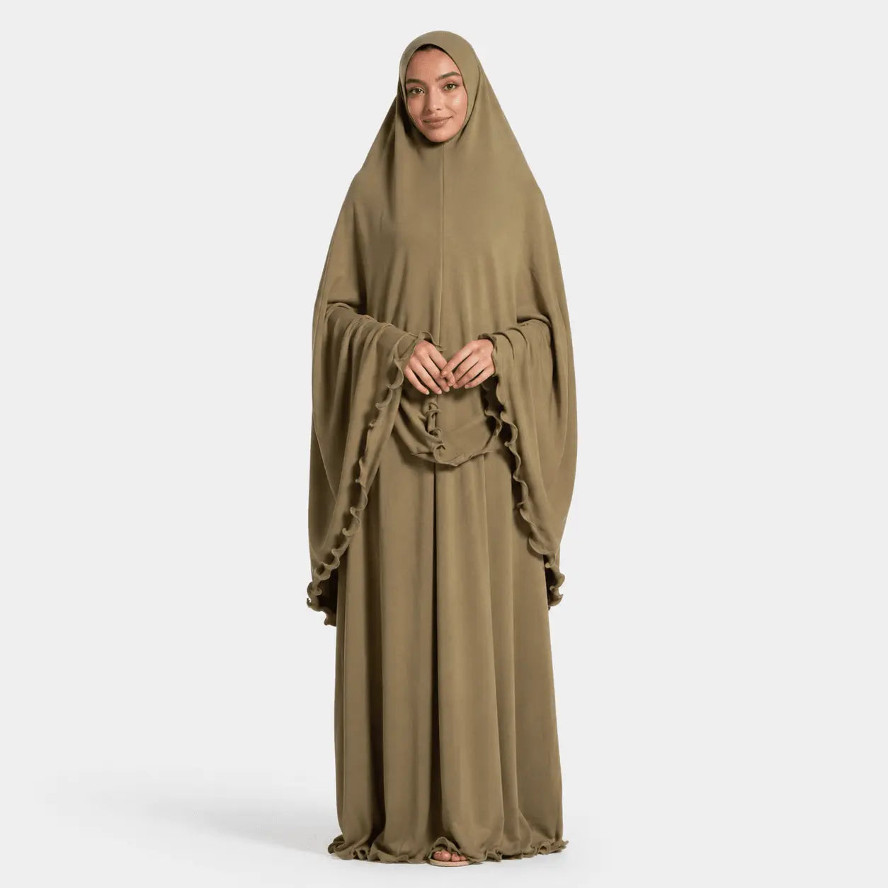 Woman wearing a long, light brown abaya on a white background