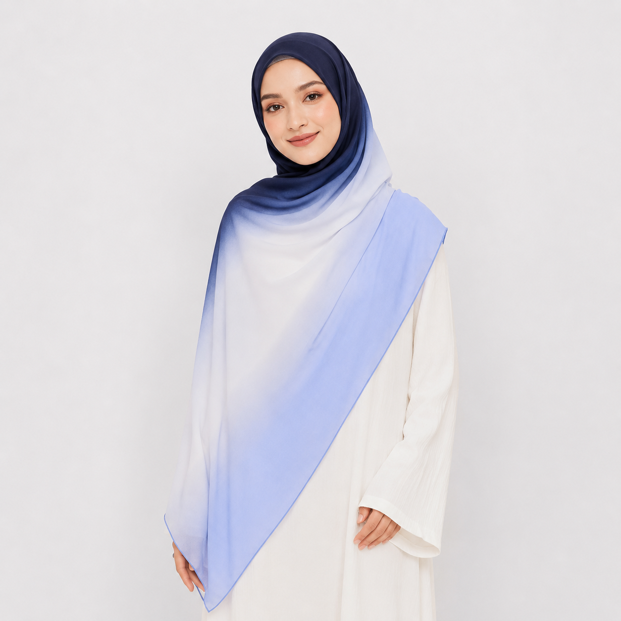 Woman wearing a gradient hijab with blue and purple colors on a white background