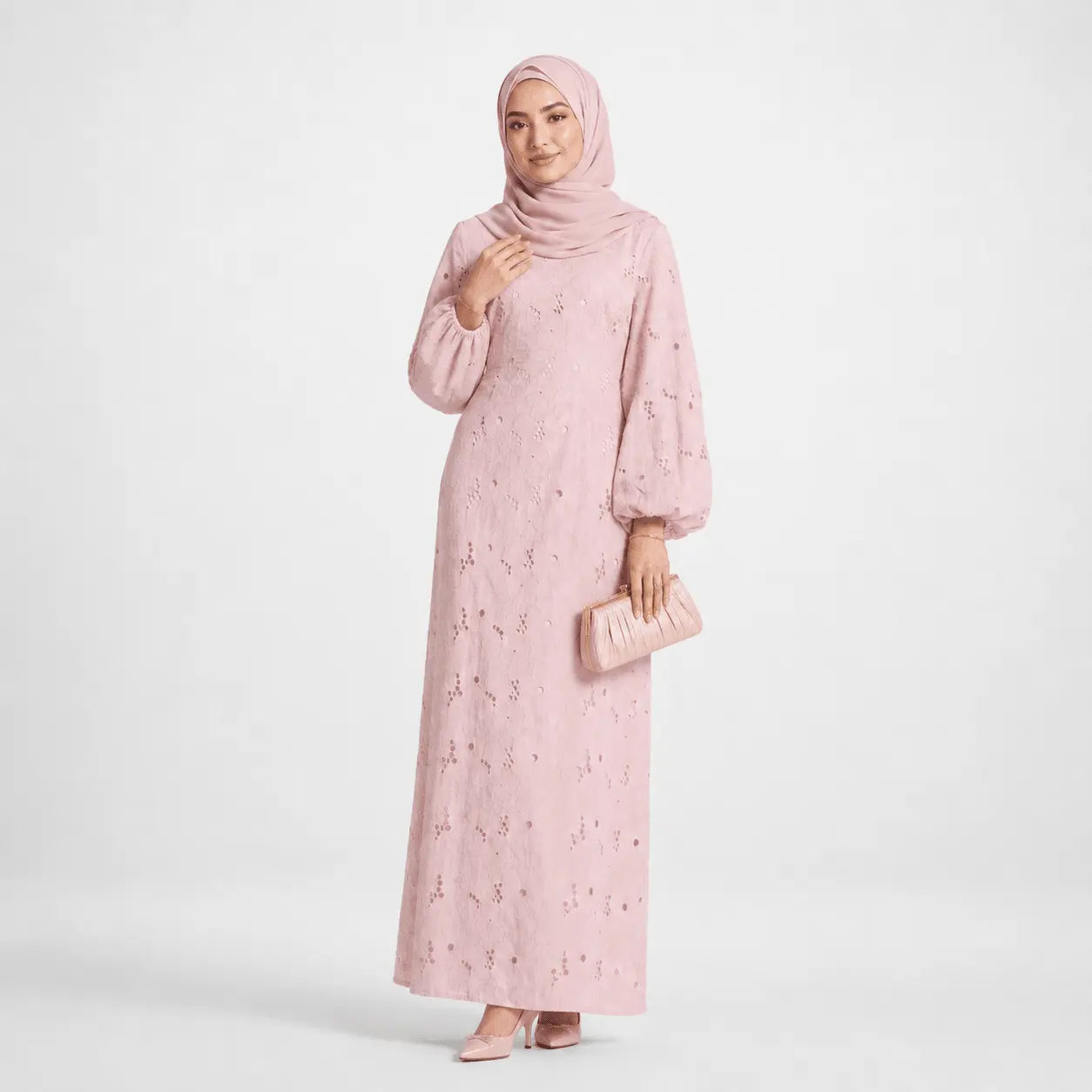 Pink modest long dress with lace details, matching hijab and clutch for elegant Muslim fashion