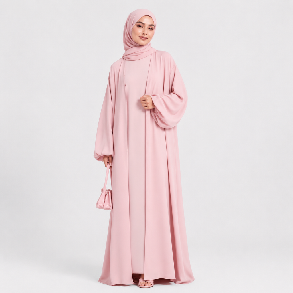 Woman wearing a pink abaya and hijab on a white background