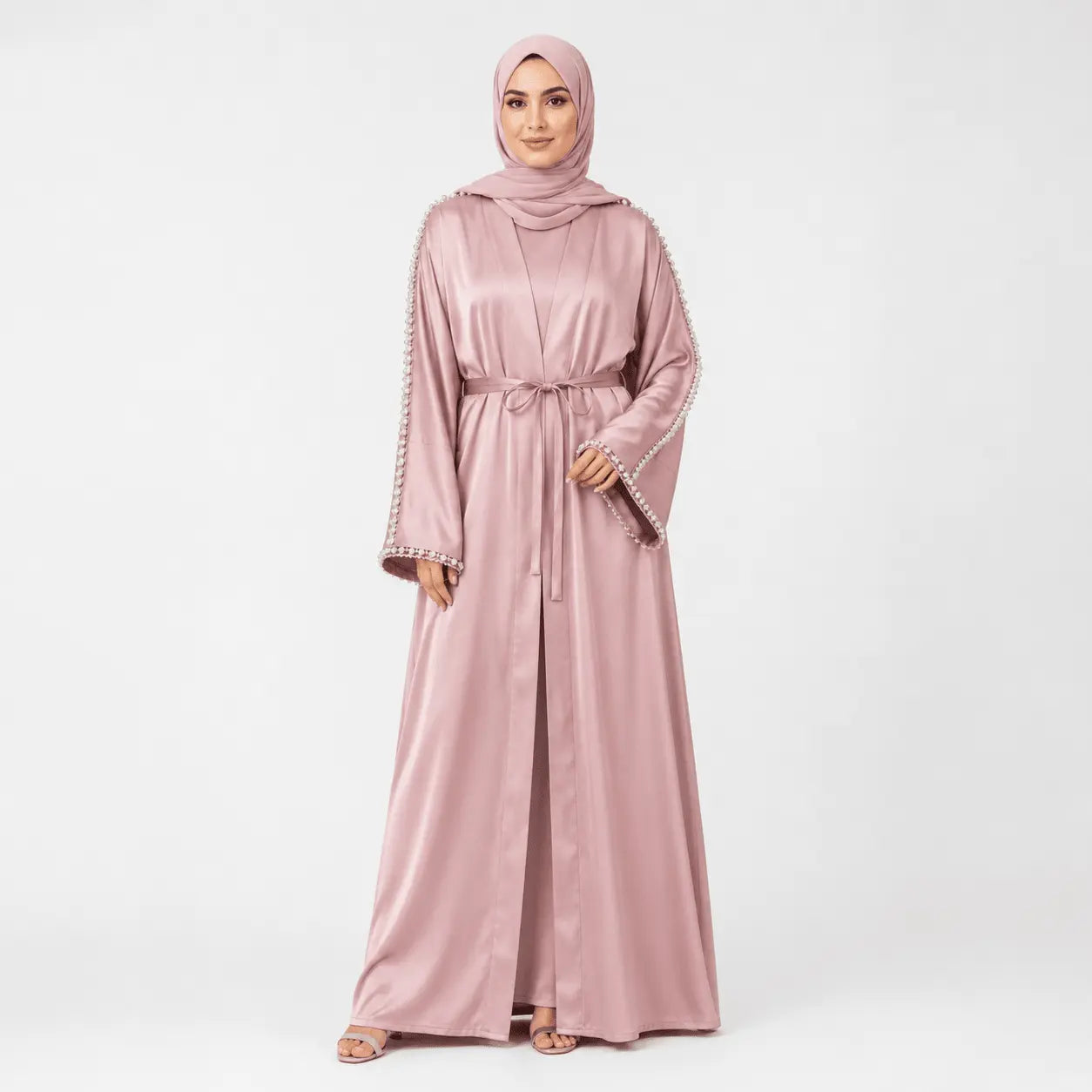 Pink abaya with intricate details on a white background