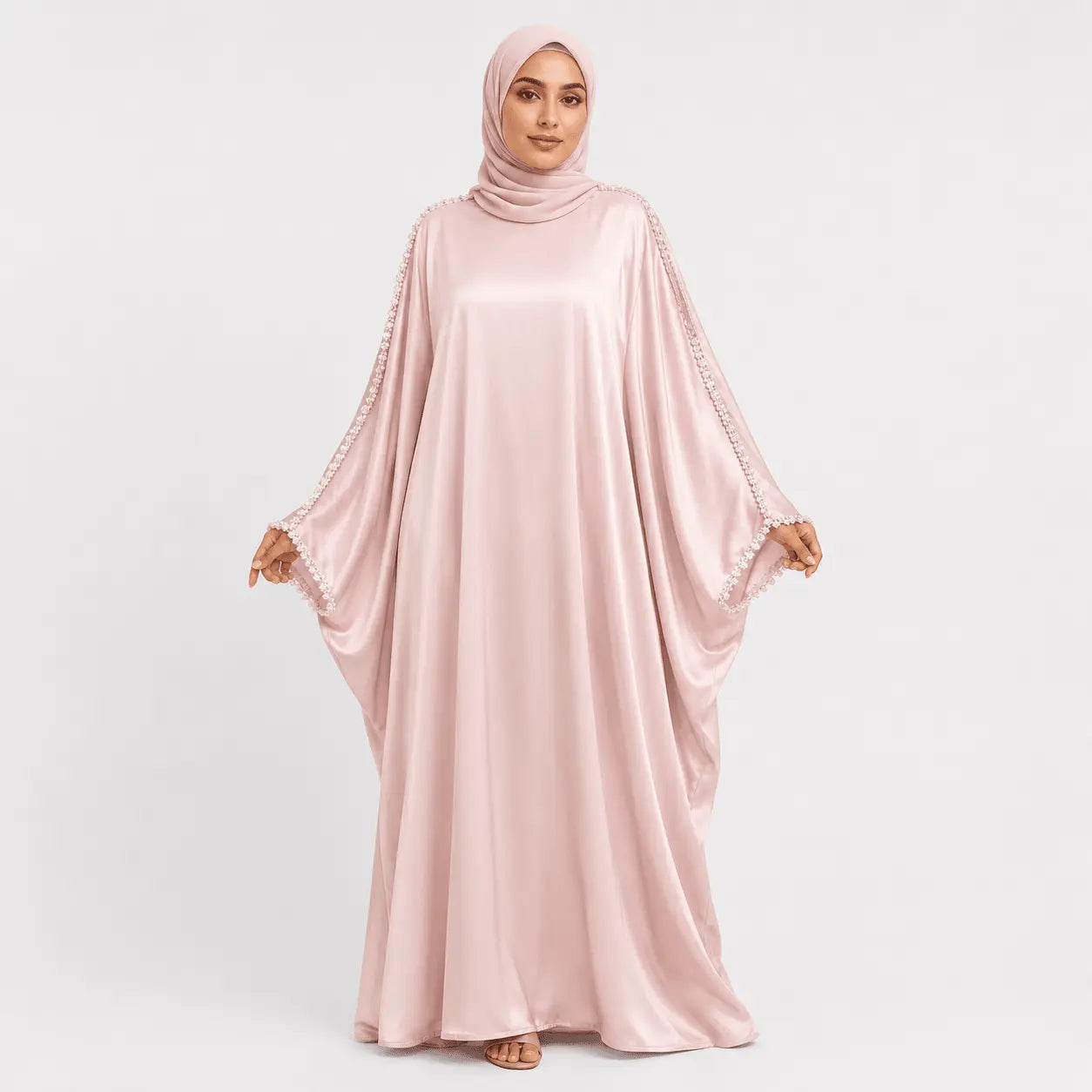 Woman wearing a pink abaya on a white background