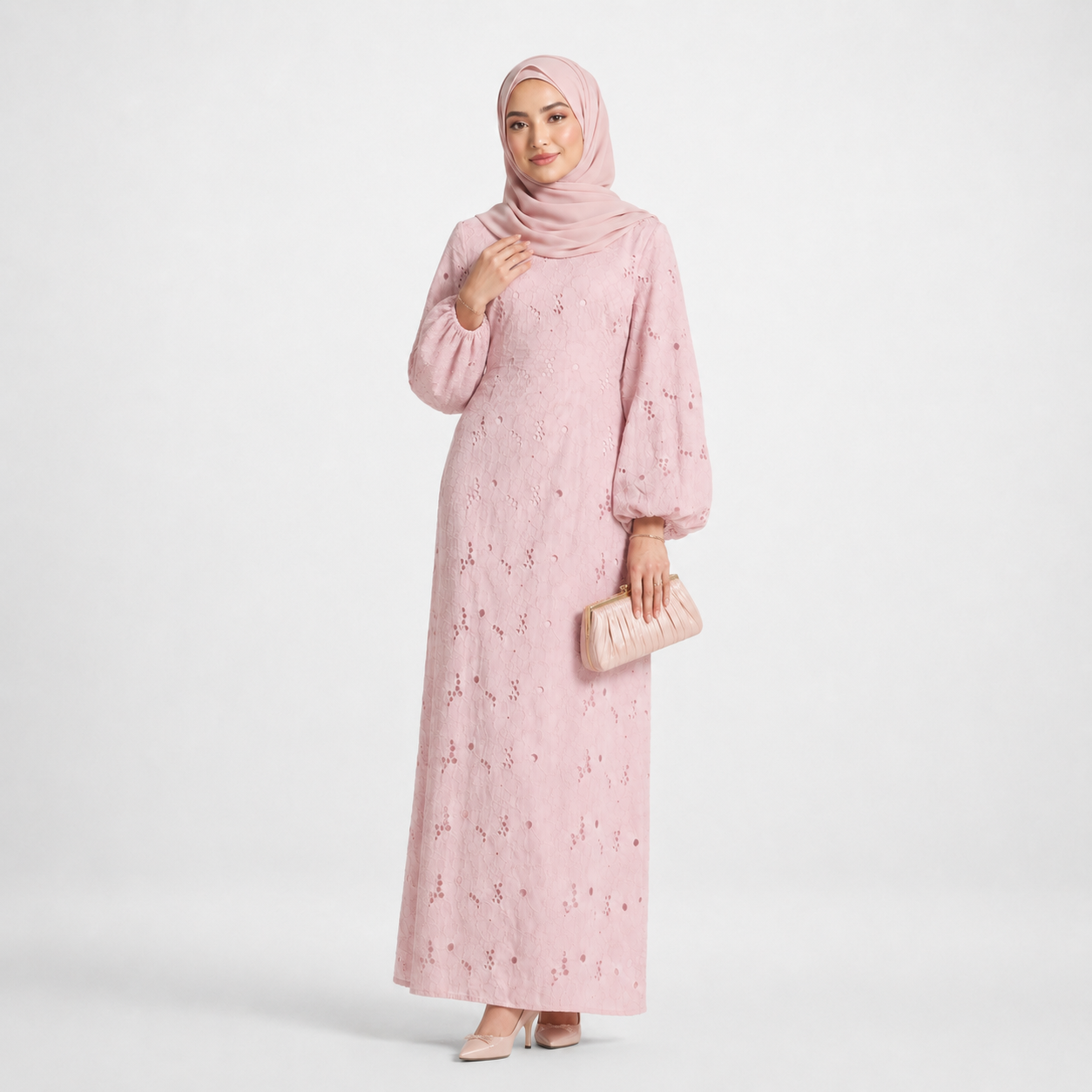 Woman wearing a pink floral dress and hijab on a white background