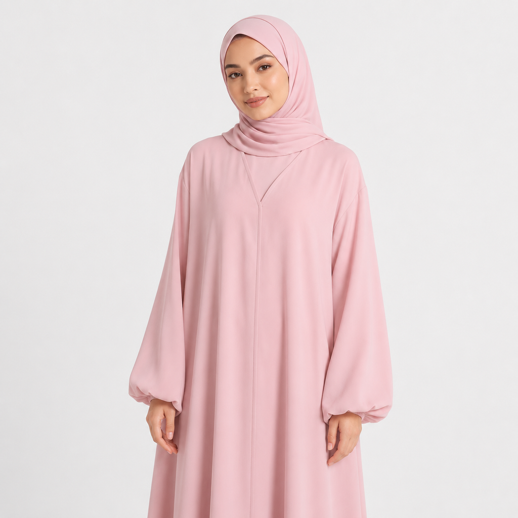 Woman wearing a pink abaya and hijab on a white background