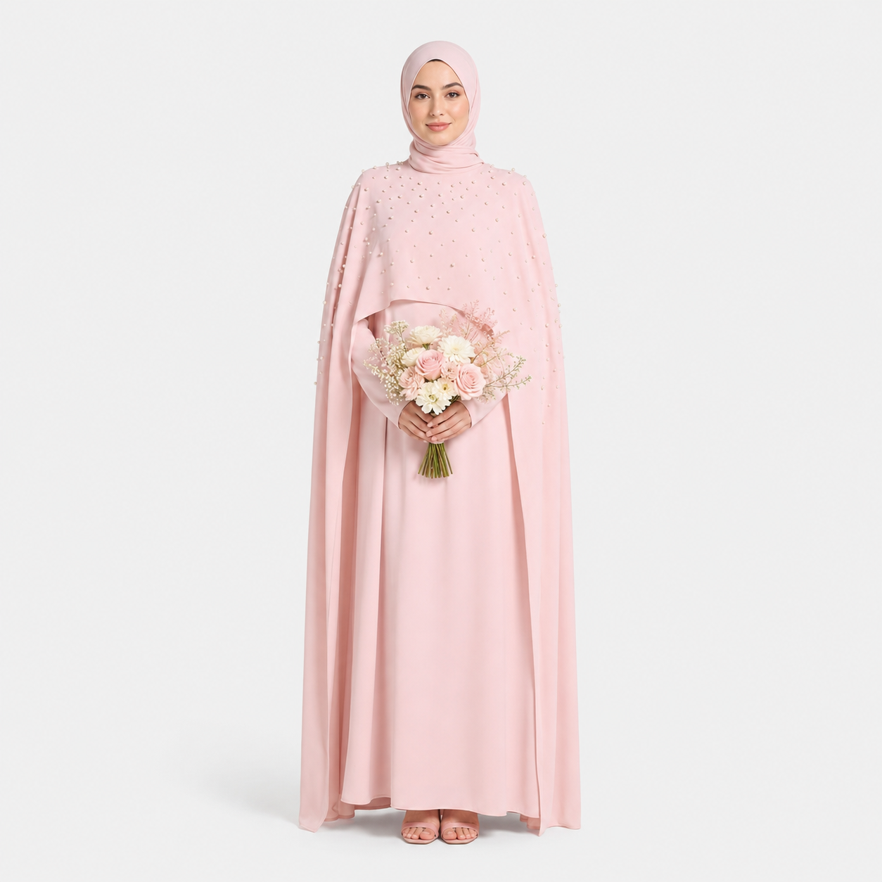 Woman in a pink dress holding flowers on a white background