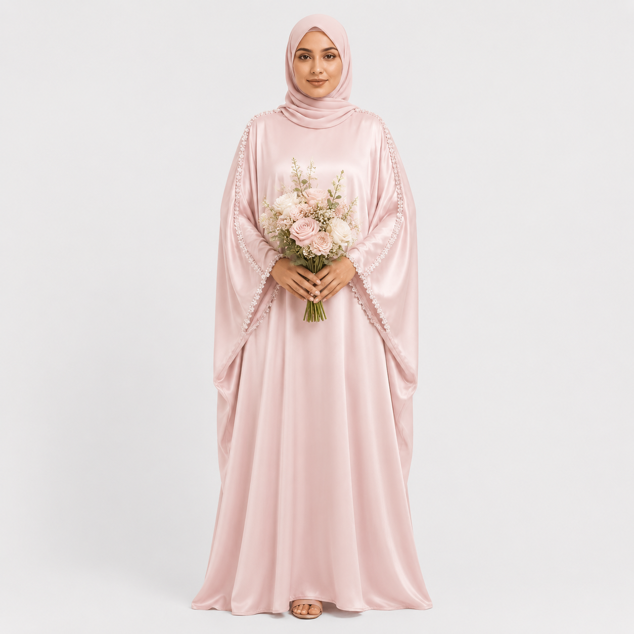 Woman in a pink dress holding flowers against a white background