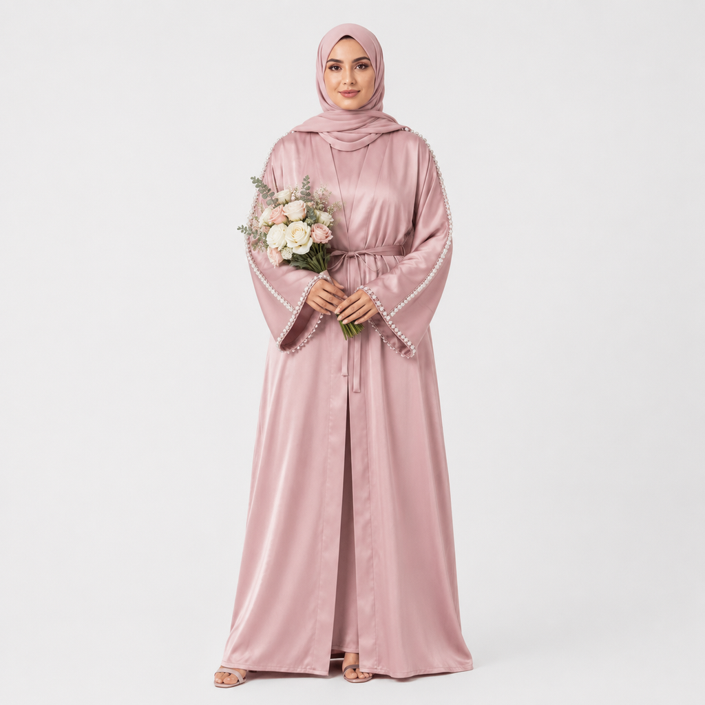 Woman wearing a pink abaya holding flowers on a white background