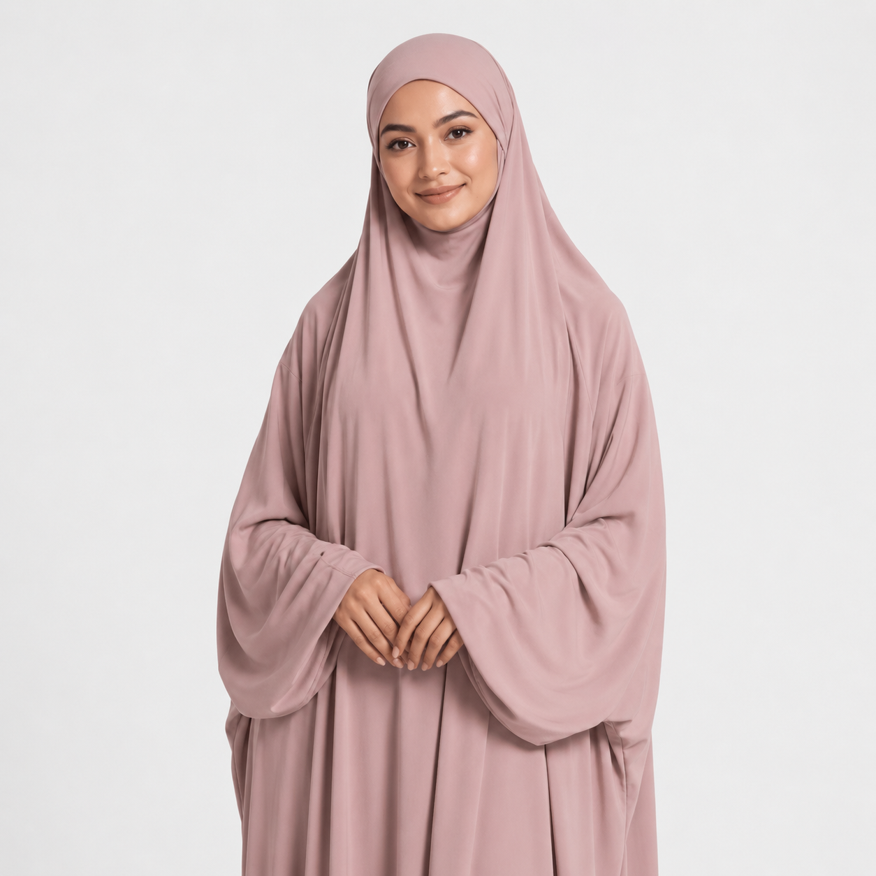 Woman wearing a pink hijab and dress on a white background