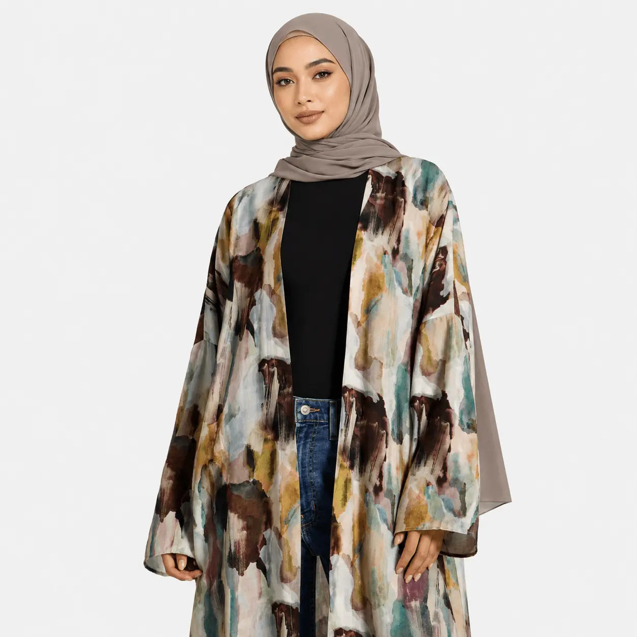 Woman wearing a patterned coat and hijab on a white background