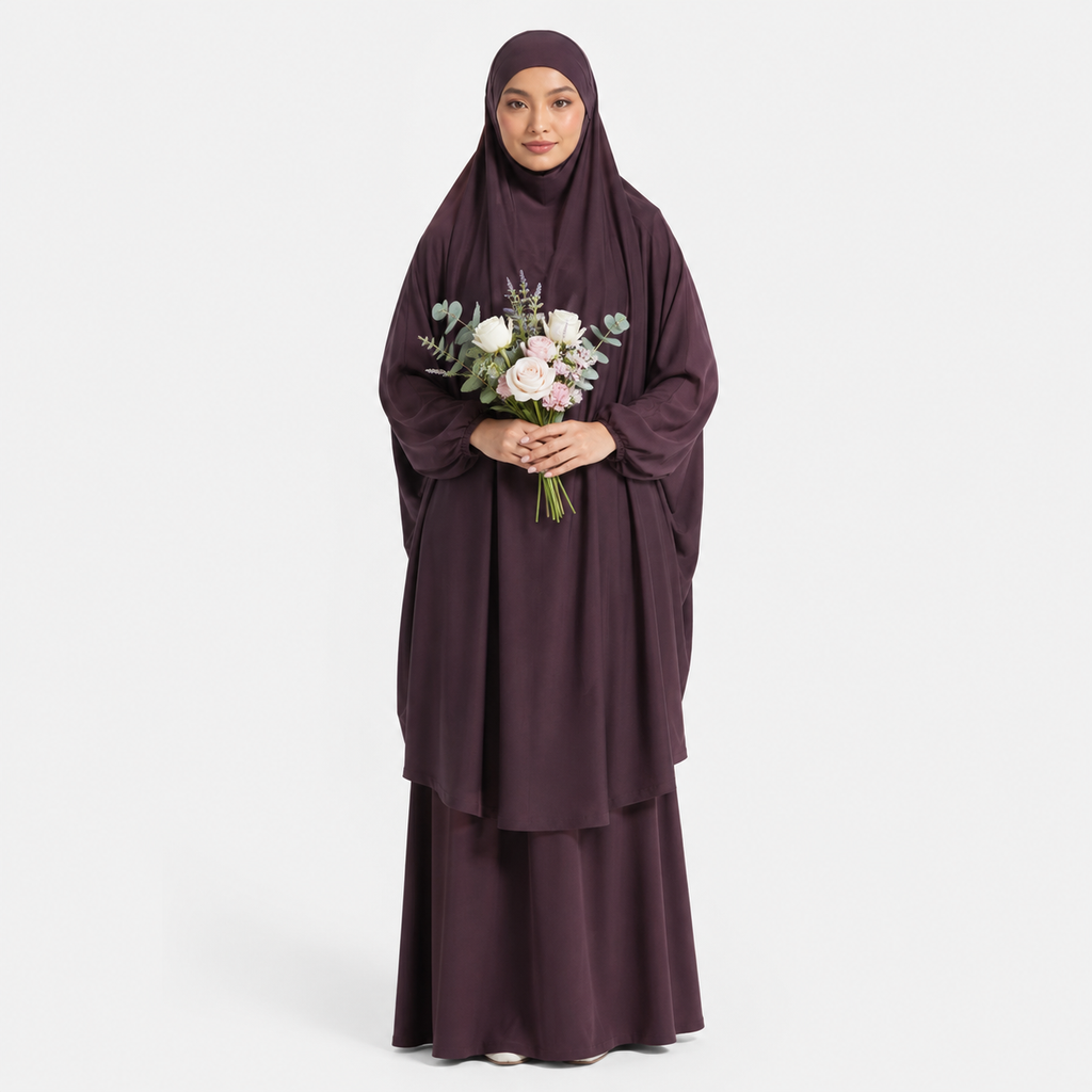 Woman wearing a dark purple abaya holding flowers on a white background